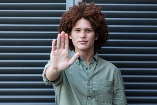 Portrait of mixed race man holding hand making a stop gesture. equal rights and justice protestors on demonstration march.