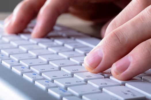 Close up of caucasian businessman typing on keyboard, isolated on grey background. business technology, communication and growth concept digitally generated composite image.