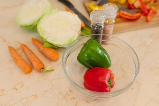 Close up of fresh vegetables lying on white countertop in kitchen. cooking and food concept.