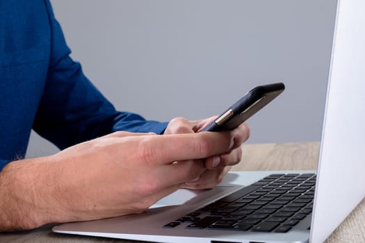 Midsection of caucasian businessman using smartphone and laptop, isolated on grey background. business technology, communication and growth concept digitally generated composite image.