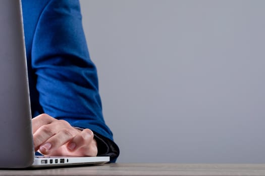 Midsection of caucasian businessman typing on keyboard, isolated on grey background. business technology, communication and growth concept digitally generated composite image.