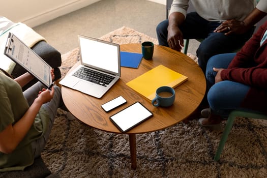 African american senior couple meeting with asian financial advisor using laptop with copy space. retirement lifestyle, elderly support and spending time at home.