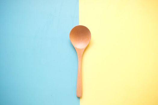 wooden cutlery forks on light yellow background