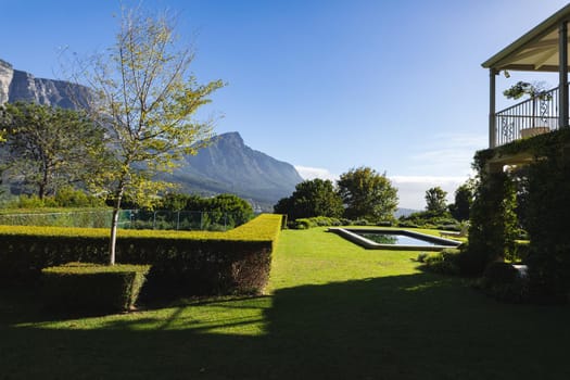 General view of tranquil swimming pool with stunning mountains countryside. outdoor retreat and holiday concept.