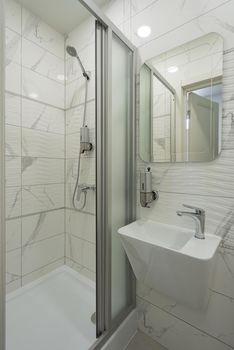 Interior of bright and modern white bathroom. shower cabin.