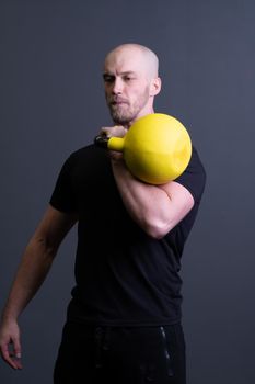 Guy with a yellow kettlebell gym anonymous young man, from sporty effort from painted from up weightlifting, asian activity. Guy down cardio, club hiit