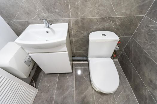 White toilet in the interior of the restroom.