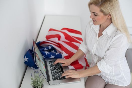 woman with laptop and usa flag. Foreign languages learning, educational online course.