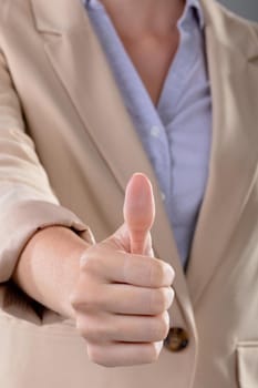 Midsection of caucasian businesswoman touching virtual interface on grey background. business, technology, communication and growth concept.