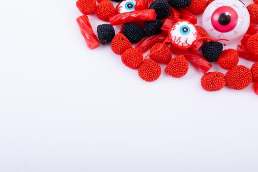 Composition of multiple halloween trick or treat eyeball sweets with copy space on white background. halloween tradition and celebration concept.