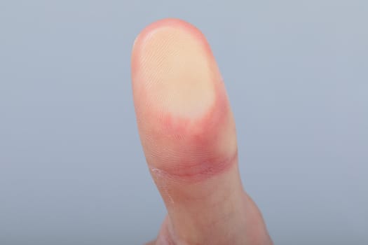 Close up of caucasian businessman touching virtual interface, isolated on grey background. business technology, communication and growth concept.