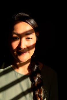 Portrait of serious asian woman standing in ray of light at home. lifestyle, leisure and spending time at home.