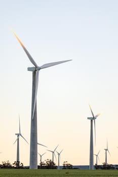 General view of wind turbines in countryside landscape with cloudless sky. environment, sustainability, ecology, renewable energy, global warming and climate change awareness.