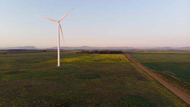 General view of wind turbine in countryside landscape with cloudless sky. environment, sustainability, ecology, renewable energy, global warming and climate change awareness.