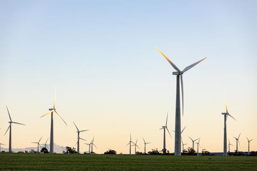 General view of wind turbines in countryside landscape with cloudless sky. environment, sustainability, ecology, renewable energy, global warming and climate change awareness.