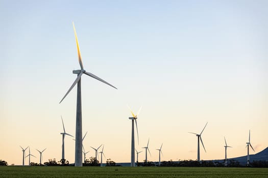 General view of wind turbines in countryside landscape with cloudless sky. environment, sustainability, ecology, renewable energy, global warming and climate change awareness.