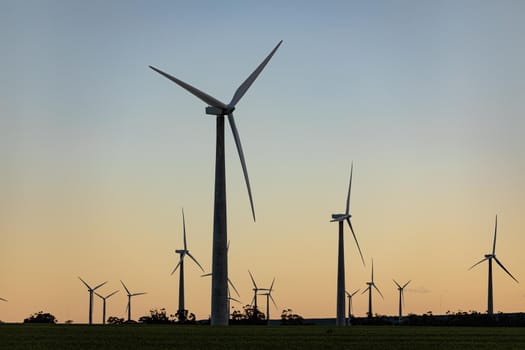 General view of wind turbines in countryside landscape with cloudless sky. environment, sustainability, ecology, renewable energy, global warming and climate change awareness.