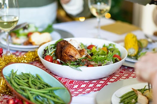 Hands of caucasian man and diverse dishes on christmas table. christmas, festivity, tradition and celebrating at home.