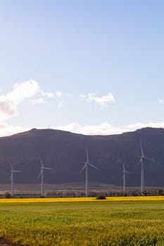 General view of wind turbines in countryside landscape with cloudy sky. environment, sustainability, ecology, renewable energy, global warming and climate change awareness.