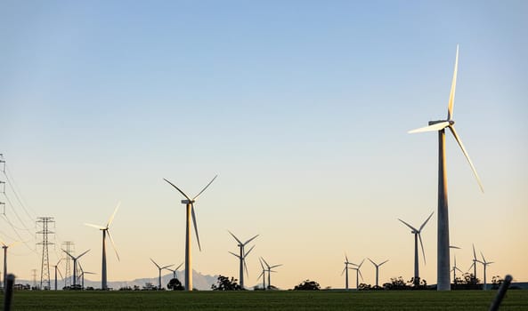General view of wind turbines in countryside landscape with cloudless sky. environment, sustainability, ecology, renewable energy, global warming and climate change awareness.