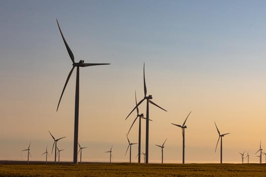 General view of wind turbines in countryside landscape with cloudless sky. environment, sustainability, ecology, renewable energy, global warming and climate change awareness.