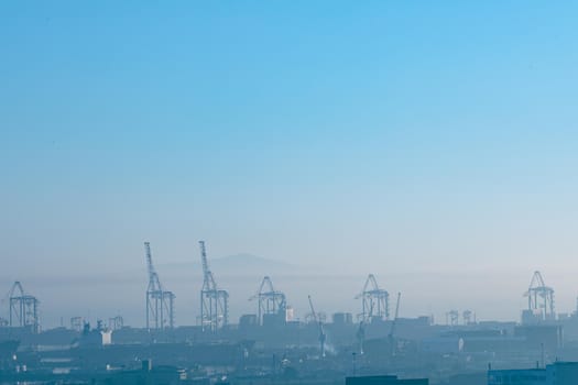 General view of cityscape with multiple modern buildings and cranes in the morning. skyline and urban architecture.