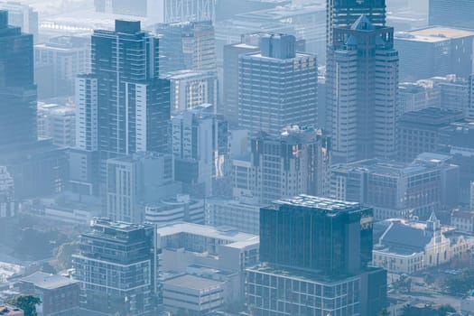 General view of cityscape with multiple modern buildings and skyscrapers in the foggy morning. skyline and urban architecture.