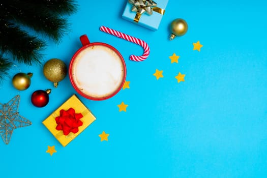 Composition of christmas decorations with baubles, presents, mug and copy space on blue background. christmas, tradition and celebration concept.