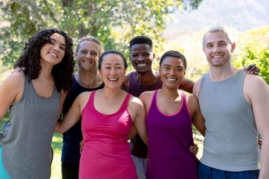 Group of happy fit diverse female and male friends holding yoga mats and taking selfie. fitness and healthy, active lifestyle.