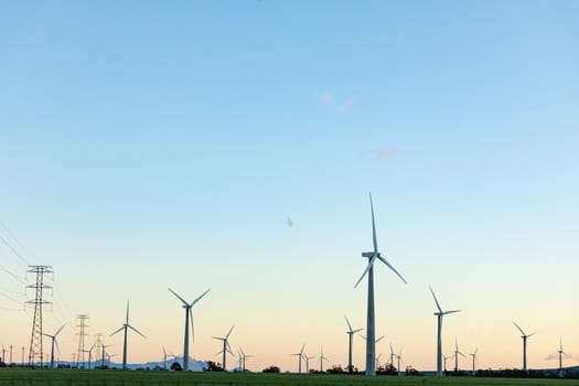 General view of wind turbines in countryside landscape with cloudless sky. environment, sustainability, ecology, renewable energy, global warming and climate change awareness.