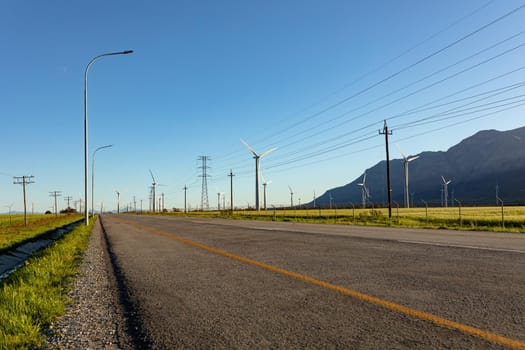General view of wind turbines in countryside landscape with cloudless sky. environment, sustainability, ecology, renewable energy, global warming and climate change awareness.
