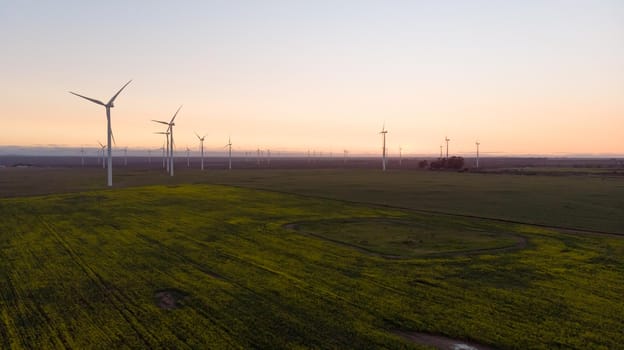 General view of wind turbines in countryside landscape with cloudless sky. environment, sustainability, ecology, renewable energy, global warming and climate change awareness.
