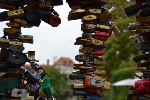 Many padlocks on the railing of a bridge that represent the eternal love between lovers