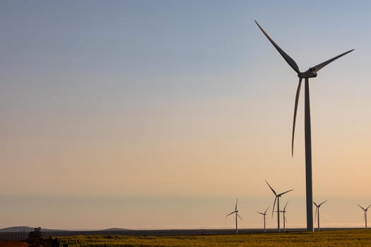 General view of wind turbines in countryside landscape with cloudless sky. environment, sustainability, ecology, renewable energy, global warming and climate change awareness.