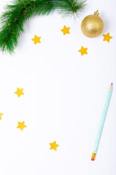 Composition of christmas decorations with bauble, stars, pencil and copy space on white background. christmas, tradition and celebration concept.