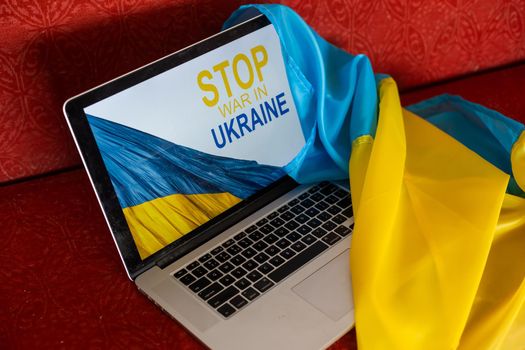 stop war and patriot. laptop, flag of ukraine.