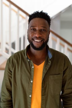 Portrait of african american man looking at camera and smiling. lifestyle, leisure and spending time at home.