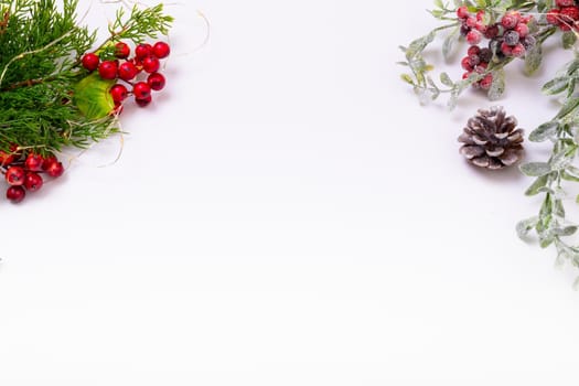 Composition of tree branches with pine cones and copy space on white background. christmas, tradition and celebration concept.