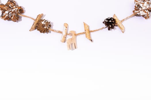 Composition of christmas decorations with pine cones and copy space on white background. christmas, tradition and celebration concept.