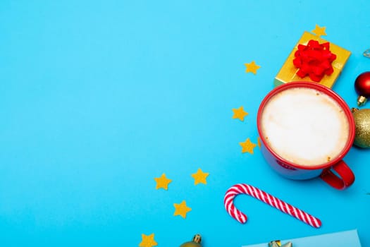 Composition of christmas decorations with baubles, presents, mug and copy space on blue background. christmas, tradition and celebration concept.