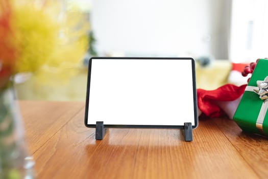 Tablet with copy space on screen lying on table with christmas decorations. christmas, festivity and communication technology.