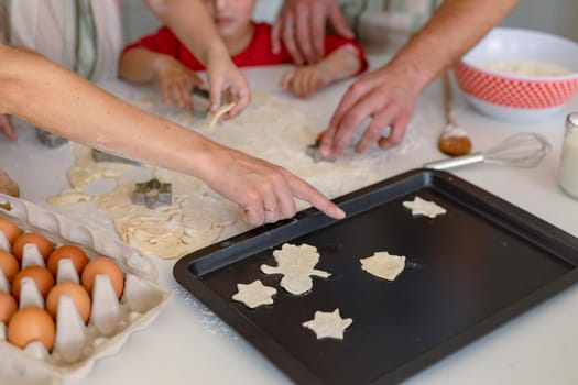 Hands of caucasian family baking together, making cookies in kitchen. family time, having fun together at home.