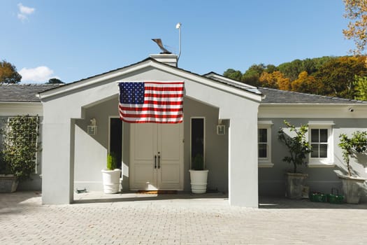 House decorated with american flag with landscape and blue sky with clouds in background. prepared for soldier returning home to family.