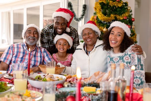 Happy multi generation family wearing santa hats, taking photo. family christmas time and festivity together at home.