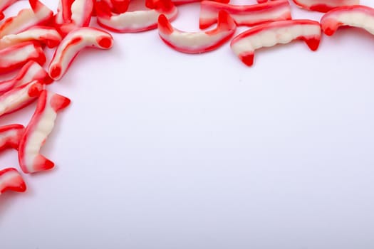 Composition of halloween jelly teeth trick or treat sweets with copy space on white background. halloween tradition and celebration concept.