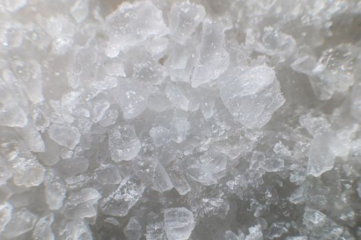 Macro view of crystals of table salt. Taste useful additive saline solutions background in shallow depth of field. Close-up.