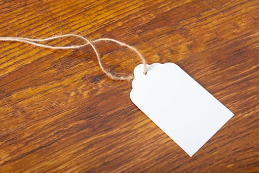 Composition of white label card with copy space on wooden background. christmas, tradition and celebration concept.