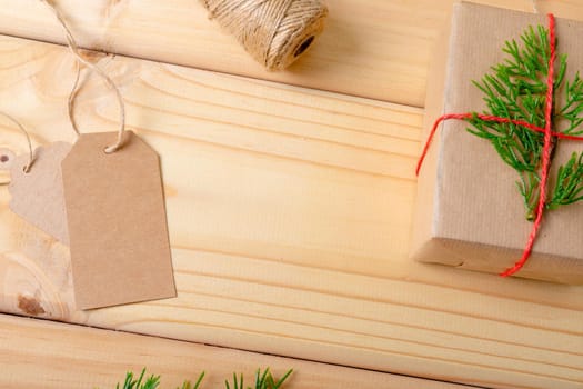 Composition of christmas decorations with present and copy space on wooden background. christmas, tradition and celebration concept.