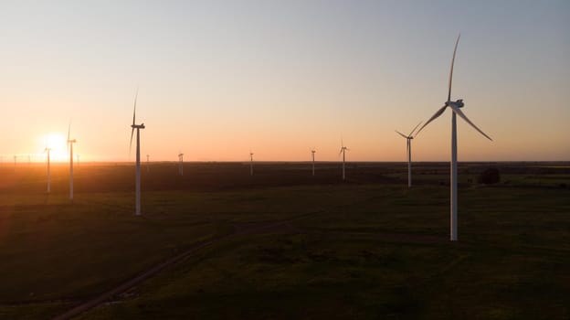 General view of wind turbines in countryside landscape during sunset. environment, sustainability, ecology, renewable energy, global warming and climate change awareness.