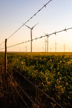 General view of wind turbines in countryside landscape with cloudless sky. environment, sustainability, ecology, renewable energy, global warming and climate change awareness.